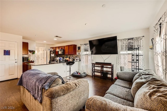 living room with dark wood-style floors and visible vents