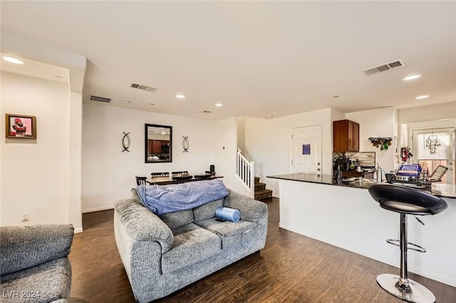 living area featuring recessed lighting, visible vents, and dark wood-style floors