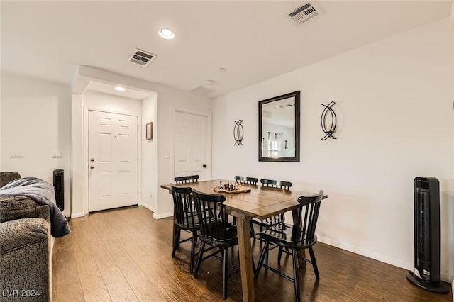 dining space featuring visible vents, baseboards, and dark wood-style flooring