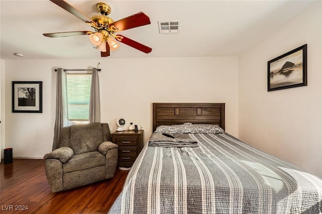 bedroom featuring visible vents, baseboards, dark wood-type flooring, and ceiling fan