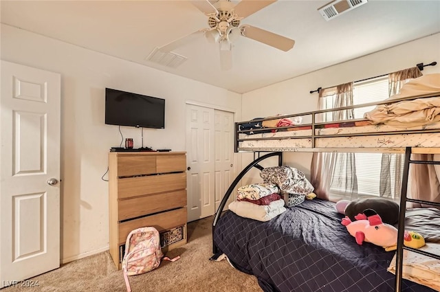 carpeted bedroom featuring multiple windows, visible vents, and a closet