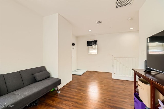 interior space with an upstairs landing, visible vents, recessed lighting, and wood finished floors