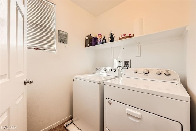 clothes washing area featuring washer and clothes dryer, laundry area, and baseboards