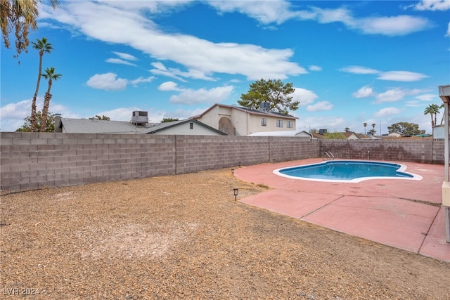 view of pool featuring central AC and a patio