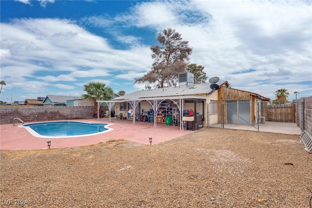 view of pool with a patio area and cooling unit