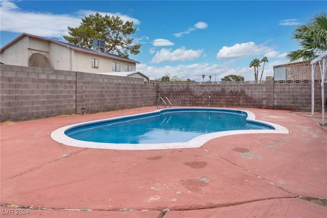 view of swimming pool with a patio area