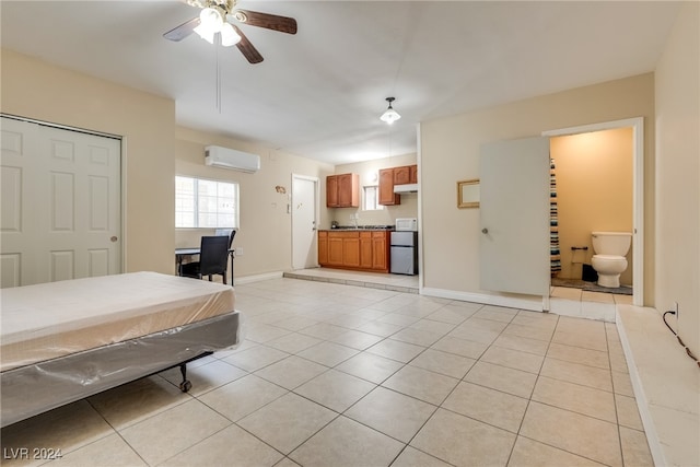 tiled bedroom with a wall mounted AC, pool table, ensuite bath, and ceiling fan