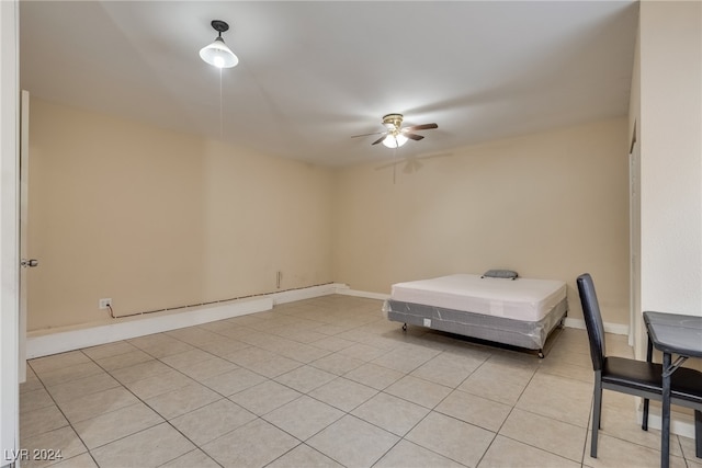 unfurnished bedroom with light tile patterned floors and ceiling fan