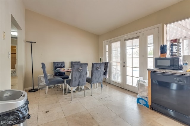 dining area with french doors and lofted ceiling