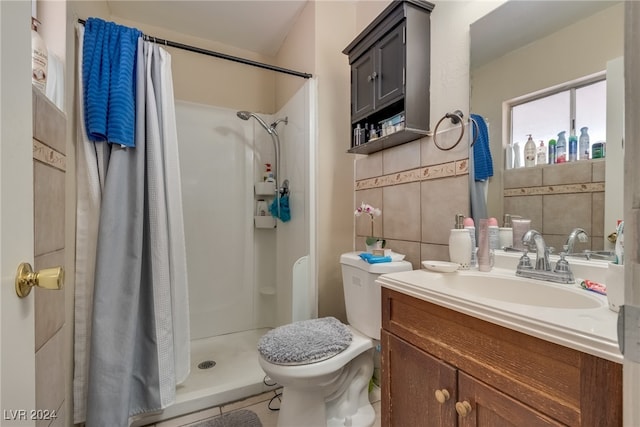 bathroom featuring tile walls, a shower with curtain, vanity, tile patterned flooring, and toilet