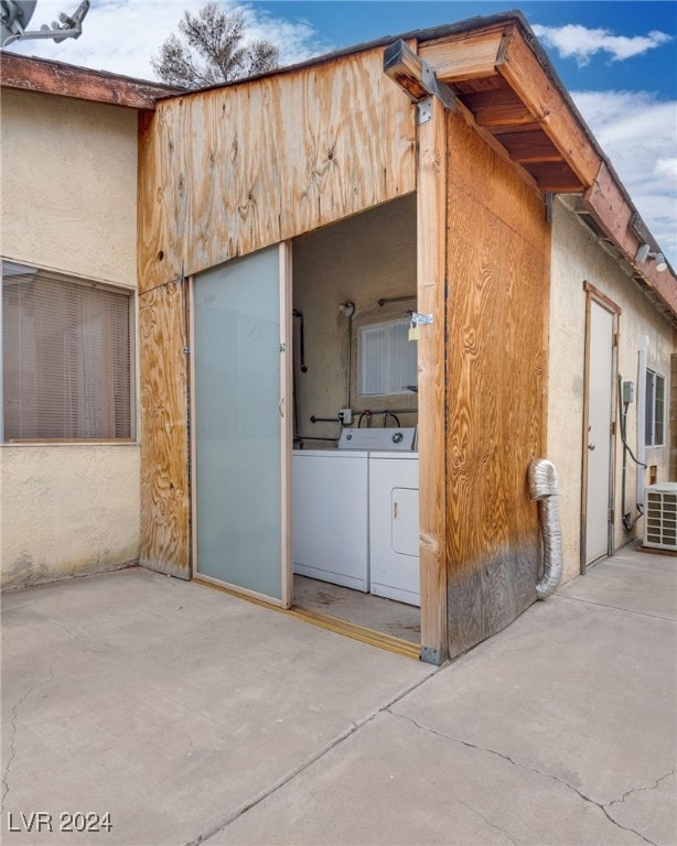 exterior space with central air condition unit, a patio area, and independent washer and dryer