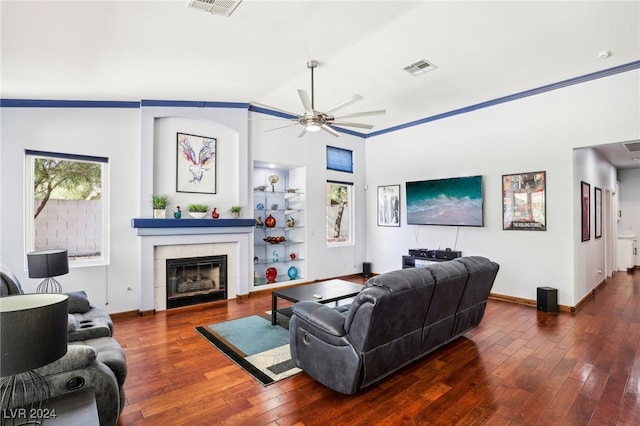 living room with a fireplace, lofted ceiling, a healthy amount of sunlight, and dark hardwood / wood-style floors