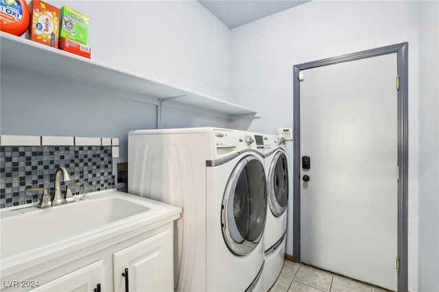 washroom featuring cabinets, separate washer and dryer, light tile patterned floors, and sink