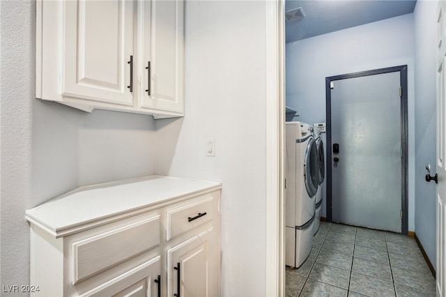 clothes washing area with washing machine and dryer and light tile patterned floors