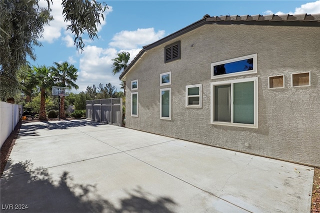 view of side of property with a patio area