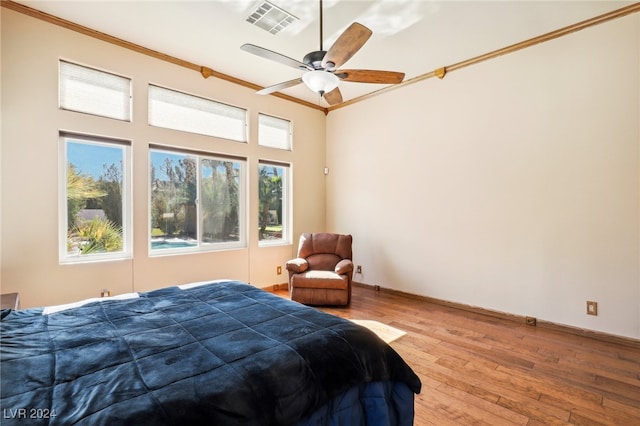 bedroom with ceiling fan, light hardwood / wood-style flooring, and crown molding