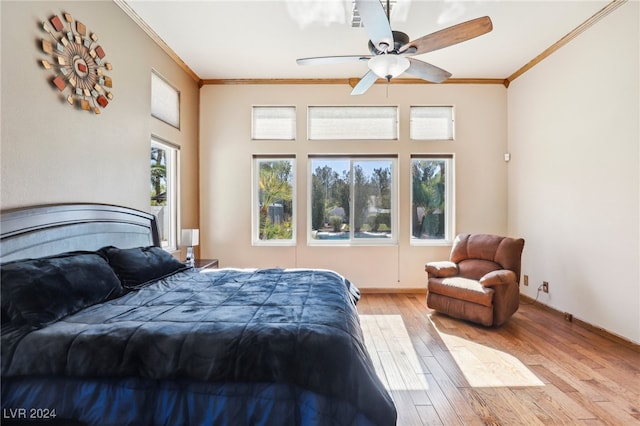 bedroom with ceiling fan, light wood-type flooring, and crown molding