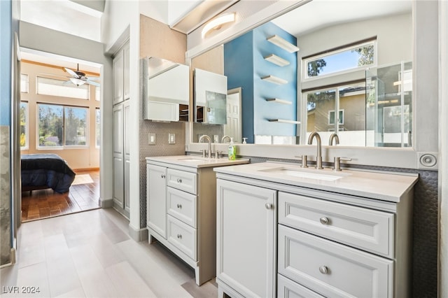 bathroom featuring hardwood / wood-style flooring, ceiling fan, vanity, and decorative backsplash