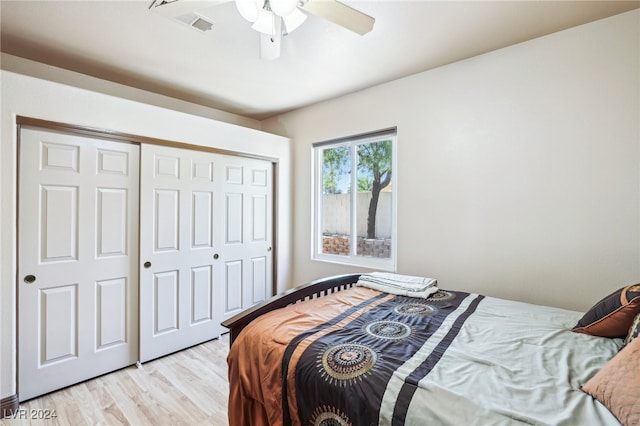 bedroom with a closet, ceiling fan, and light hardwood / wood-style floors