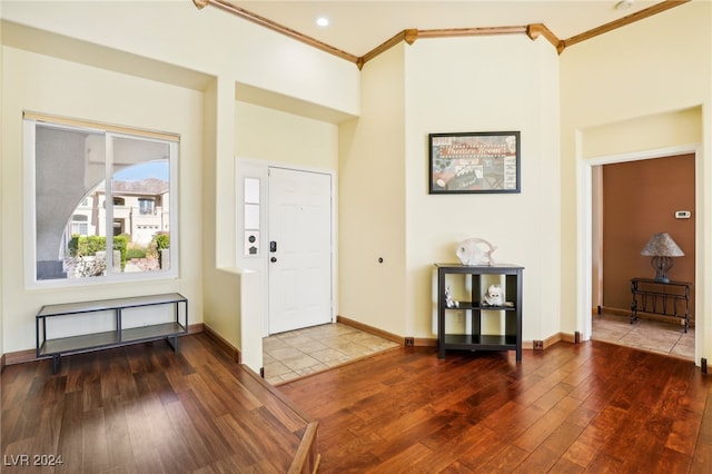 entryway with dark hardwood / wood-style floors and ornamental molding