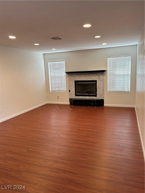 unfurnished living room with dark hardwood / wood-style flooring