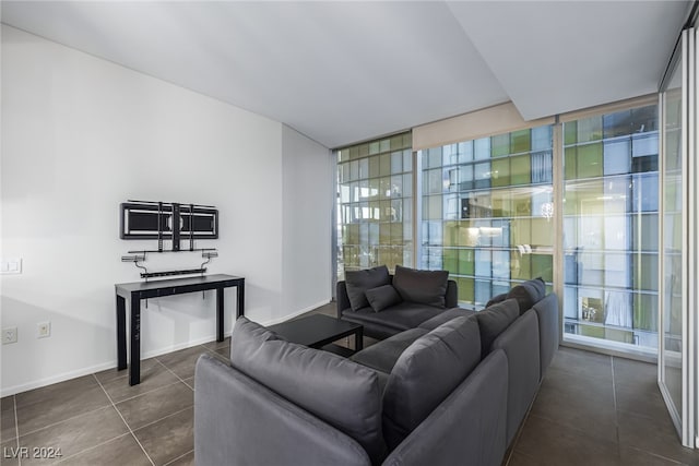 living room with expansive windows and dark tile patterned flooring