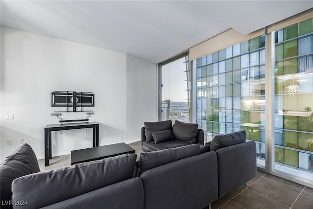 living room featuring dark tile patterned flooring and floor to ceiling windows