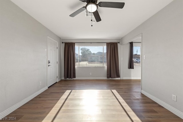 unfurnished room featuring dark wood-type flooring and ceiling fan