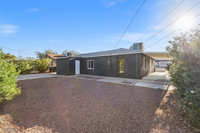 rear view of house featuring central air condition unit