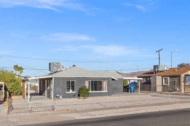 ranch-style home featuring cooling unit