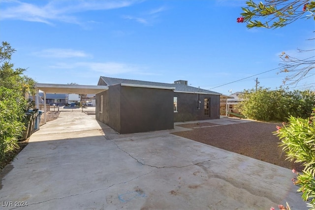 back of property featuring a carport