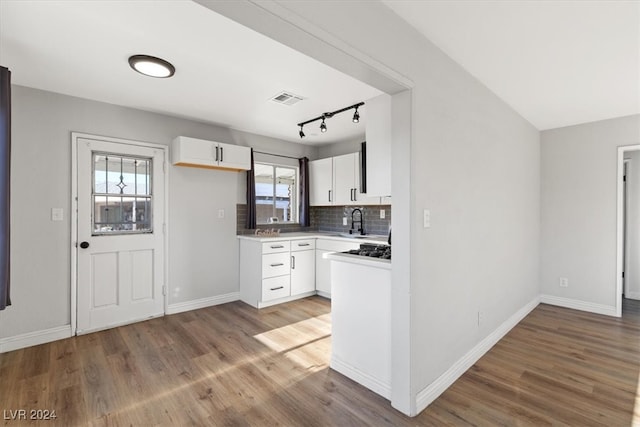 kitchen featuring plenty of natural light, hardwood / wood-style floors, and white cabinets