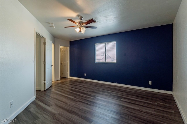 unfurnished bedroom with ceiling fan and dark hardwood / wood-style flooring