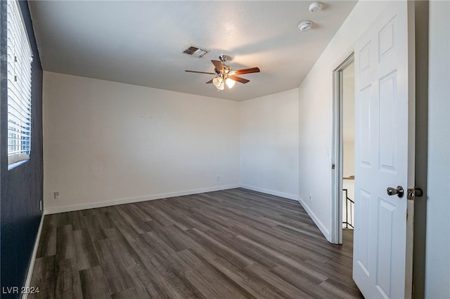 unfurnished room featuring dark hardwood / wood-style floors and ceiling fan