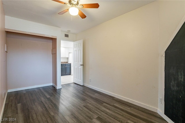 unfurnished bedroom with a closet, ceiling fan, and dark hardwood / wood-style floors