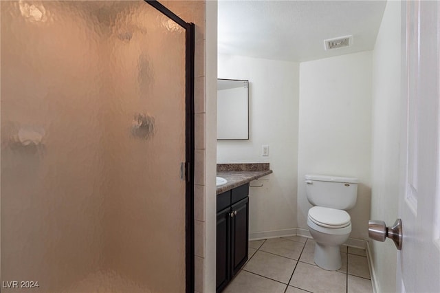 bathroom featuring tile patterned floors, vanity, toilet, and an enclosed shower