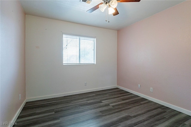 spare room with dark wood-type flooring and ceiling fan