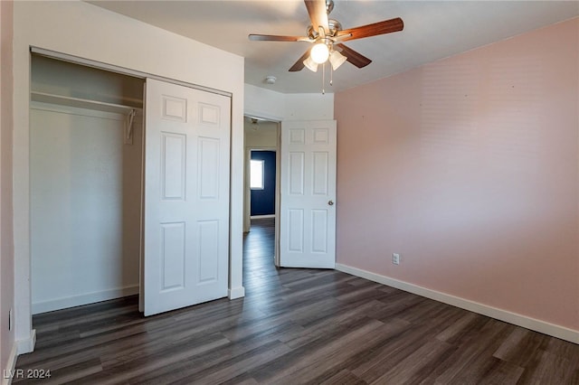 unfurnished bedroom with ceiling fan, dark hardwood / wood-style floors, and a closet