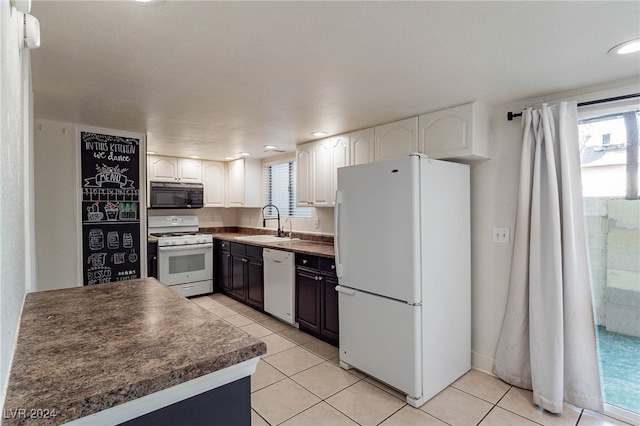 kitchen with white cabinetry, white appliances, sink, and light tile patterned floors