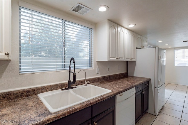 kitchen featuring sink, light tile patterned flooring, dark brown cabinets, white cabinetry, and white appliances