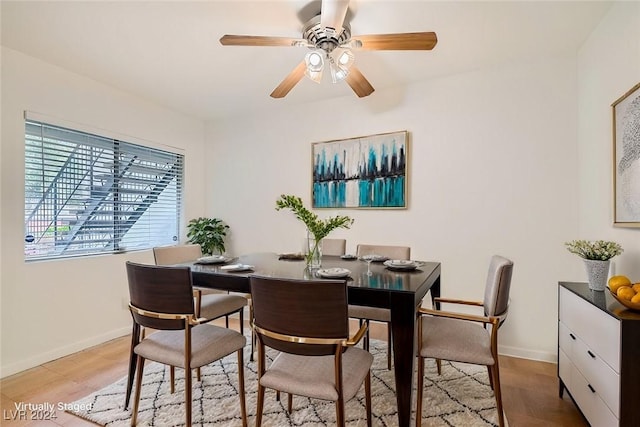 dining area featuring ceiling fan and light wood-type flooring