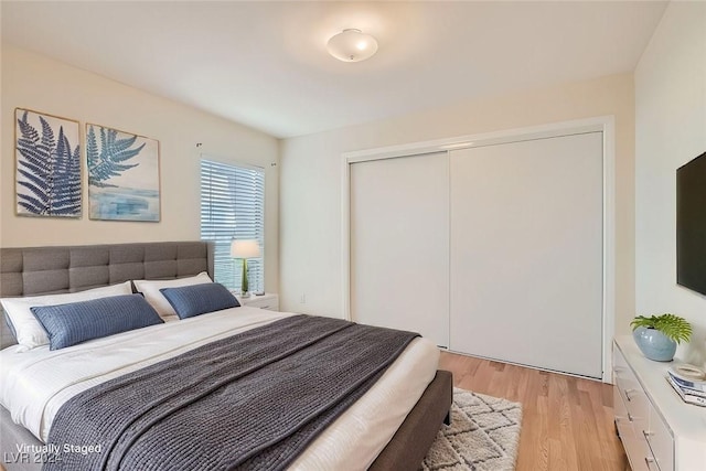 bedroom featuring light hardwood / wood-style flooring and a closet