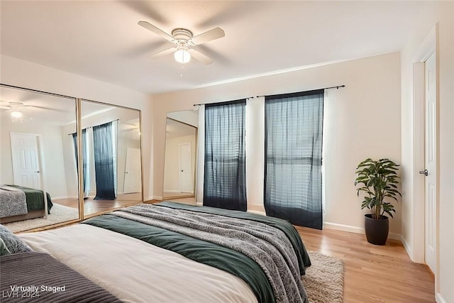 bedroom with ceiling fan, a closet, and light hardwood / wood-style flooring