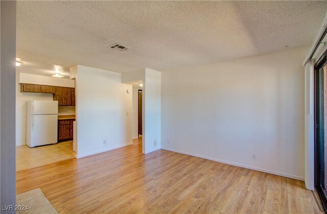 518 Elm St Unit H, Boulder City, NV 89005 - spare room featuring light wood-style floors, a textured ceiling, and baseboards