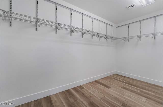 spacious closet with light hardwood / wood-style floors