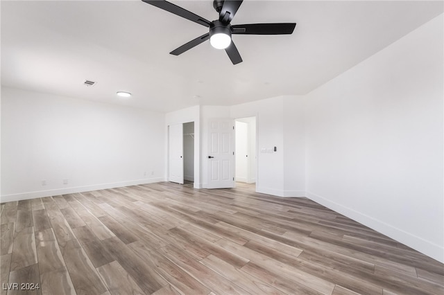 empty room featuring ceiling fan and light hardwood / wood-style floors