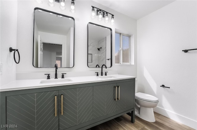 bathroom with walk in shower, wood-type flooring, vanity, and toilet