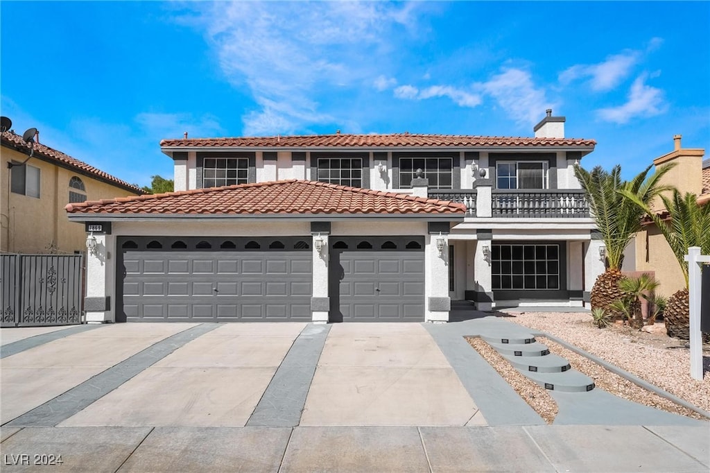 mediterranean / spanish home with a garage