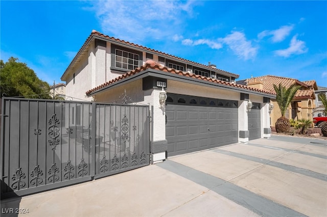 mediterranean / spanish home with a garage