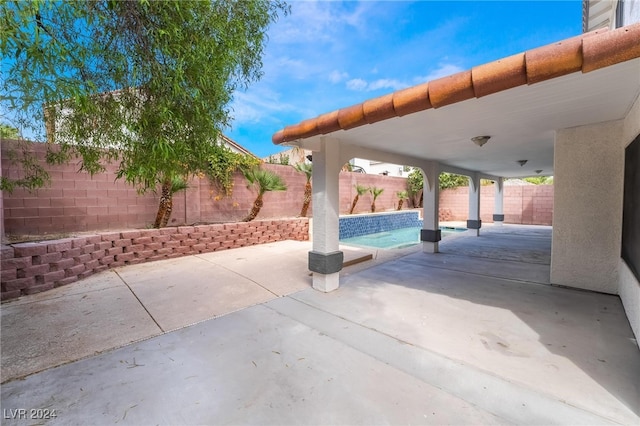 view of patio with a fenced in pool